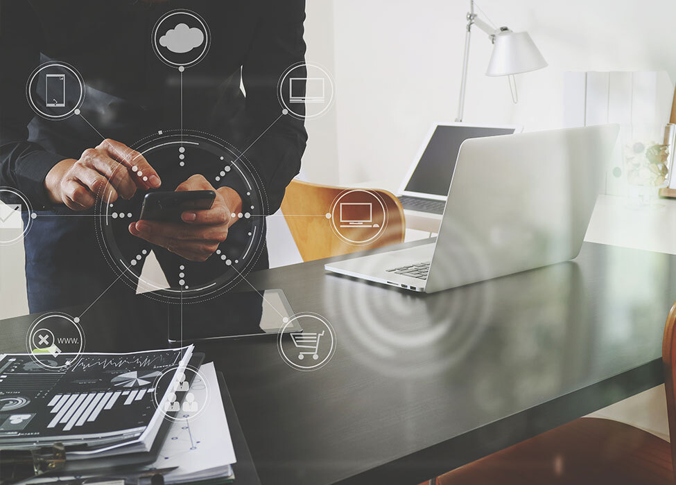 Smart Office Technology | Person working on their phone with icons floating around