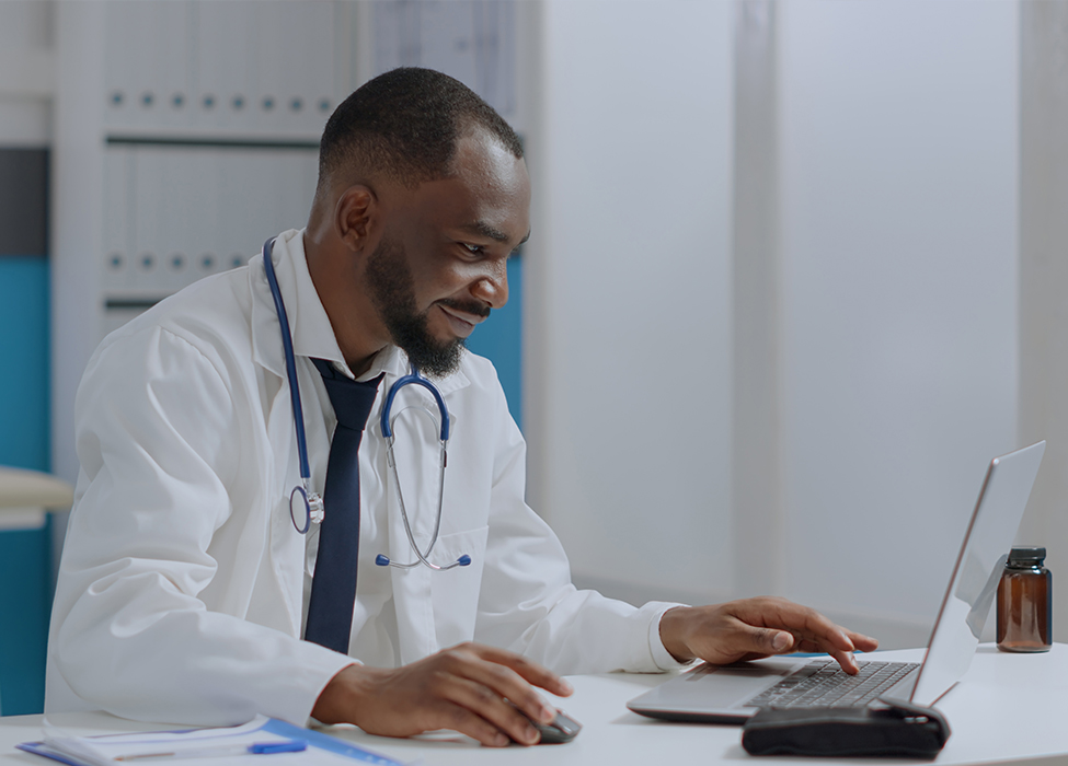 claims adjudication | Close up of two people, one a healthcare professional, talking and looking over papers and a calculator