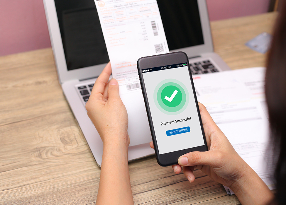 Financial Operations | A close up of a person making an online payment using their phone